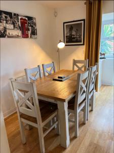 a dining room table with chairs and a wooden table at San Pedro Lodge Rochester in Rochester