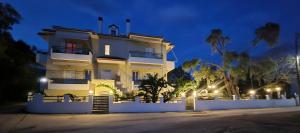 a large white house at night with lights at Sun Ray Sivota 5 in Sivota