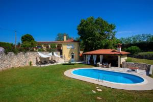 a backyard with a pool and a house at Romantic Villa Green Sky with Pool and Garden in Nedeščina