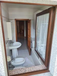 a bathroom with a toilet and a sink at Casa Sartori in Caderzone Terme
