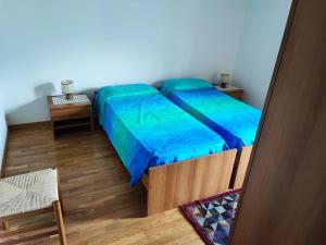 a small room with two beds and a table at Casa Sartori in Caderzone Terme