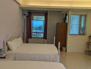 Postel nebo postele na pokoji v ubytování Taroko Bay B&B