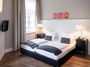 Cama ou camas em um quarto em Hotel Victoria