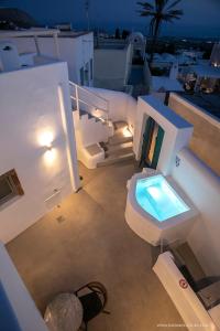 a bathroom with a toilet and a swimming pool at AnnaFani Villa in Pirgos