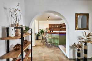 a hallway with an archway leading to a kitchen with a bar at Charm Hotel, Hersonissos in Hersonissos