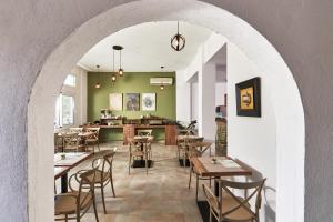 an archway with tables and chairs in a restaurant at Charm Hotel, Hersonissos in Hersonissos