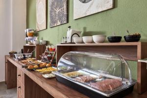 a buffet with meat and other food on a table at Charm Hotel, Hersonissos in Hersonissos