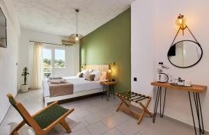 a bedroom with a bed and a green wall at Charm Hotel, Hersonissos in Hersonissos