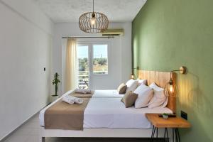 a bedroom with a large bed and a window at Charm Hotel, Hersonissos in Hersonissos