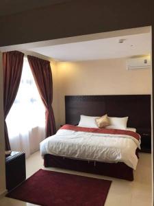 a bedroom with a large bed and a window at In Taibah in Al Madinah