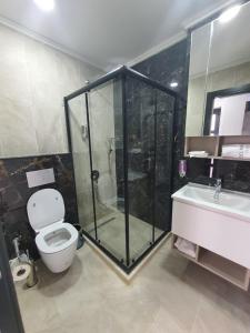 a bathroom with a shower and a toilet and a sink at Del Mare Park in Kyrenia