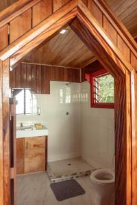 a bathroom with a shower and a toilet in it at Leleana Resort Kolombangara Island 