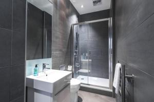 a bathroom with a toilet and a sink and a shower at Artillery Lane in London