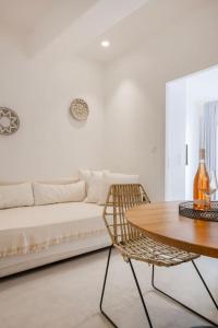 a living room with a white couch and a table at Luxury Apartment Center of Mykonos Town - Sleeps 3 in Mýkonos City