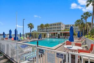 a pool with chairs and umbrellas next to a hotel at Stunning Bay Views from your Private Balcony in Tampa