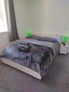 a bedroom with a large bed with a comforter at Top Quality Modern Southsea Garden Apartment Sleeps 4 People in Portsmouth