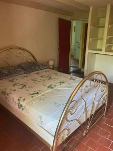 a bedroom with a bed with a floral blanket at Maison a Rustrel (A coté du Colorado Provençal ) in Rustrel