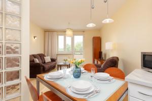 a kitchen and living room with a table and chairs at Spacious & Quiet 1 Bedroom Apartment in Pruszków by Renters in Pruszków