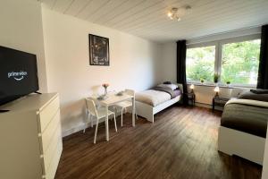 a small living room with a couch and a table at Work & Stay Apartment with Balcony in Osnabrück