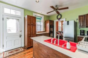 a kitchen with a red sink and a refrigerator at Historic Petersburg Row Home in Petersburg