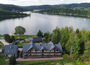 an aerial view of a house on a lake at Apartamenty Na Stoczku nad jeziorem z widokiem na jezioro JACUZZI in Polańczyk