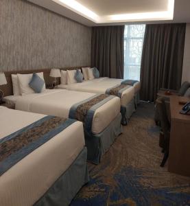 Cette chambre comprend 4 lits et un bureau. dans l'établissement Valy Hotel, à Médine