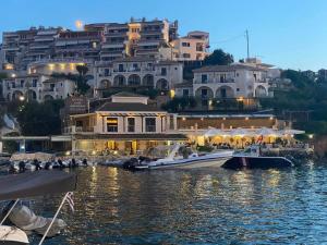a group of boats in a body of water with buildings at Sun Ray Sivota 7 in Syvota