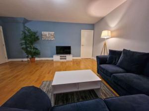 a living room with a couch and a table at Canal Street Apartment in Manchester