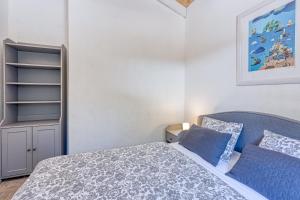 a bedroom with a bed with blue pillows at Eco House Casa Grigia Zabodarski Beach - Happy Rentals in Cunski