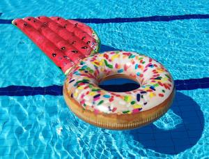 a donut and two water melons in a swimming pool at Domki MEDYK in Jantar +12 photos