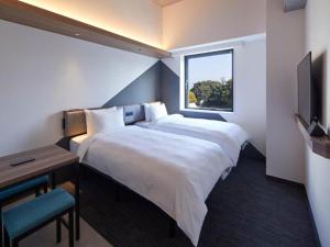 Rúm í herbergi á Prince Smart Inn Atami