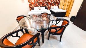 a glass table and chairs in a room at Hotel Rajyashree Palace in Varanasi