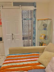 a room with a door and a couch and a window at Hendon Homestay in Hendon