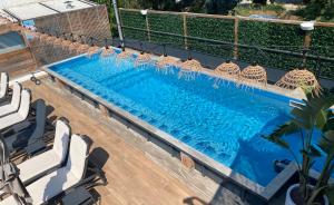 an overhead view of a swimming pool with chairs at Les Alcyons in Le Lavandou