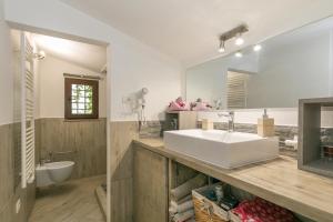 a bathroom with a white sink and a mirror at La Poggiolina in Toscana in Guardistallo +21 photos