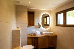 a bathroom with a sink and a mirror at Eden du Boenlesgrab in Lautenbach +4 photos