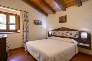 En eller flere senge i et værelse på Casa vacanze a Tortolì
