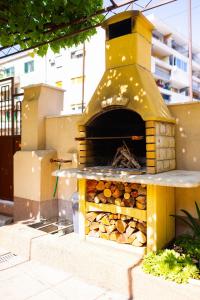 un four à pizza avec une pile de bois de feu dans l'établissement Antique Garden Villa, à Split