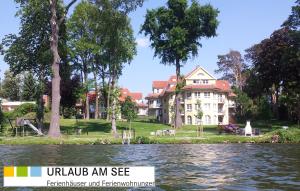 a house from the water with the words ukuda anise fertilisation at Villa Seeblick Bad Saarow in Bad Saarow