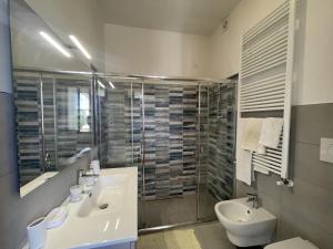 a bathroom with a sink and a toilet and a shower at Oasi di Relax in Santa Maria di Scacciano