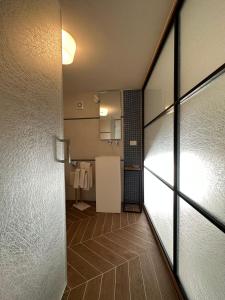 a hallway of a bathroom with a door open at View Room in Bacoli