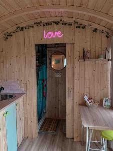 a small house with a sign that says love at Roulotte „couleur“ in Condom +16 photos