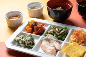 a plate of food with different foods on a table at Hotel Vista Nagoya Nishiki in Nagoya