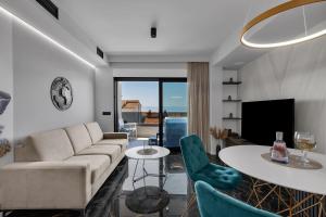 a living room with a couch and a table at Lux Apartment Dolce Vita - Private HotTub in Makarska