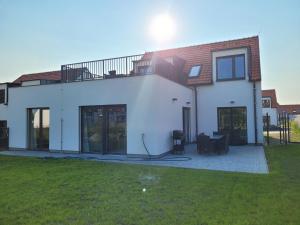 Casa blanca con ventanas grandes y césped en Zámek na dlani Mikulov, en Mikulov