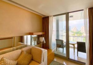 a living room with a couch and a table and a balcony at The Westin Shenzhen Nanshan in Shenzhen