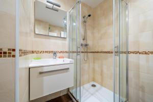 a bathroom with a sink and a shower at Cap Salou in Salou +18 photos