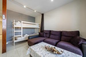 a living room with a couch and a bunk bed at Cap Salou in Salou