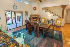 a dining room with a table and a fireplace at Spectacular Views, Heated Pool, and Outdoor BBQ in Tucson