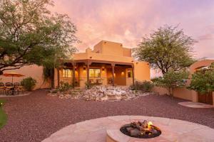 a house with a fire pit in front of it at Spectacular Views, Heated Pool, and Outdoor BBQ in Tucson